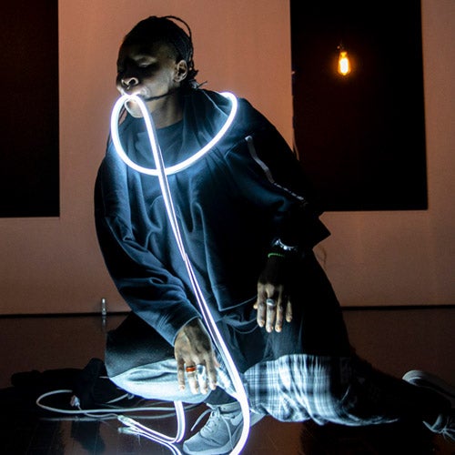 UCR faculty member Sage Ni’ja Whitson performs with rope lights.