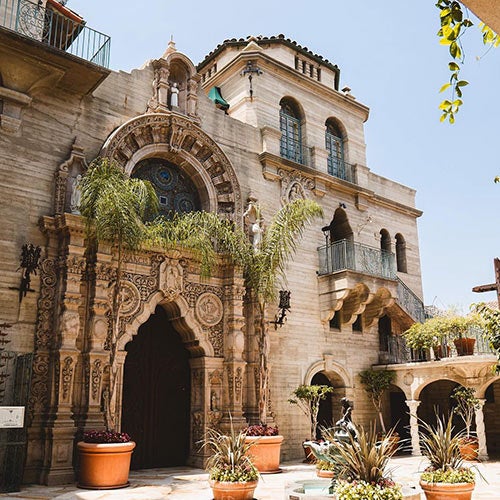 Two UCR students happily enjoying boba tea drinks.