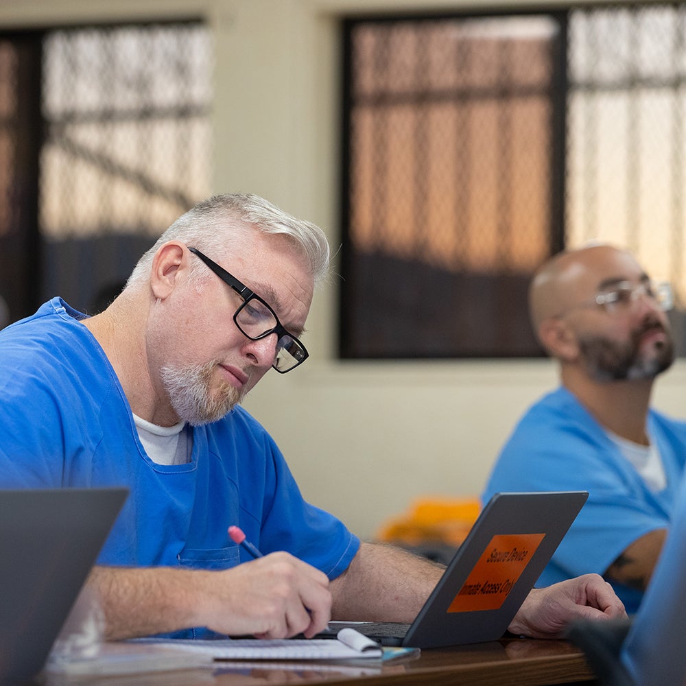 An incarcerated UCR student takes notes during class as part of the prison program, LIFTED, Leveraging Inspiring Futures Through Educational Degrees, on Thursday, October 24, 2024, at the Norco California Rehabilitation Center. (Photo by UCR/Stan Lim)