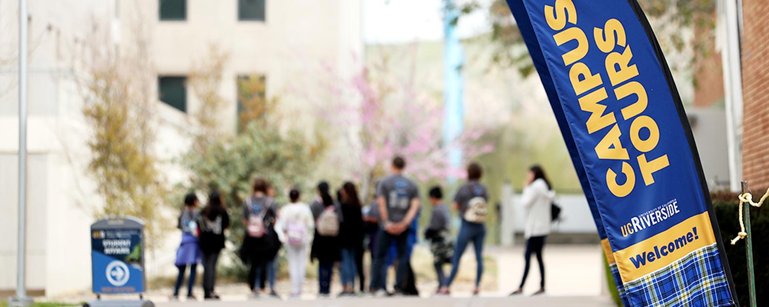 A group of UCR visitors gather outside the Campus Tours office.