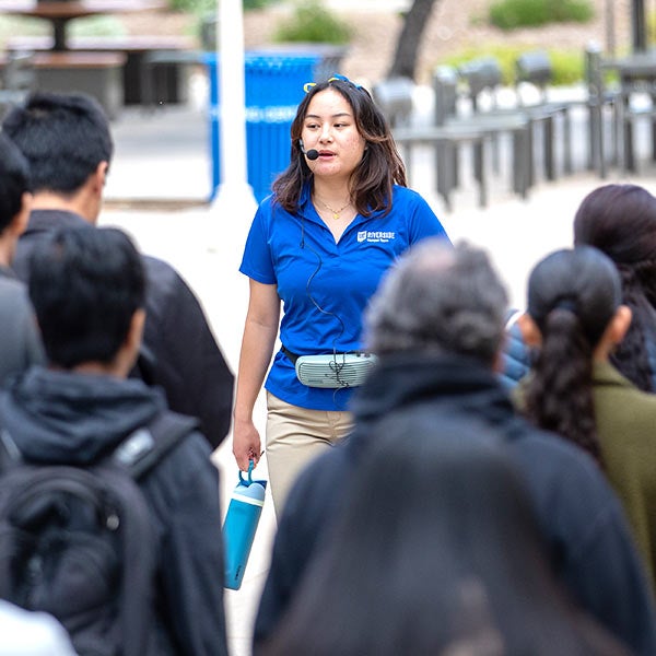 A Campus Tours Guide leads visitors on Highlander Day.