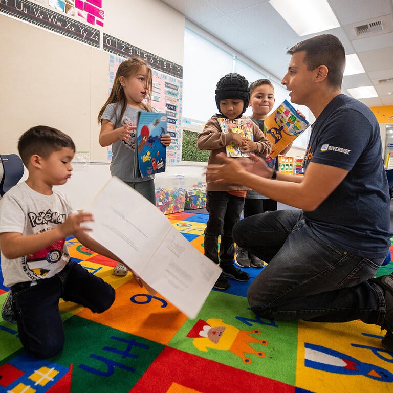 School teacher speaking with children