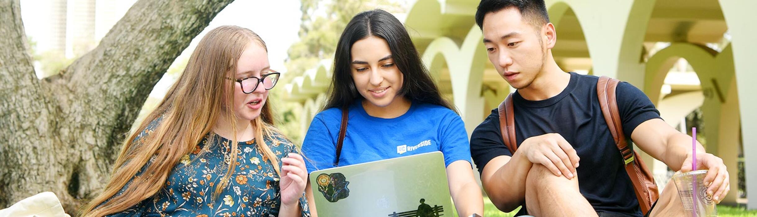 UCR students looking at a laptop