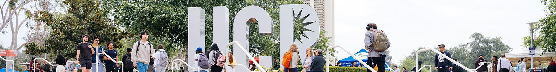 Students walking near the UCR sign