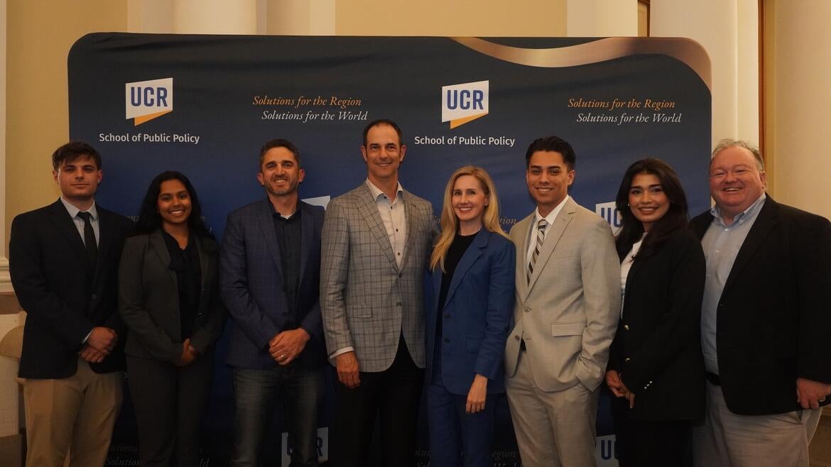 Group photo of debators, judges, and the dean