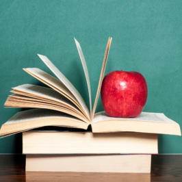 Books with an apple sitting on top