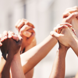 People holding hands and raising them in the air