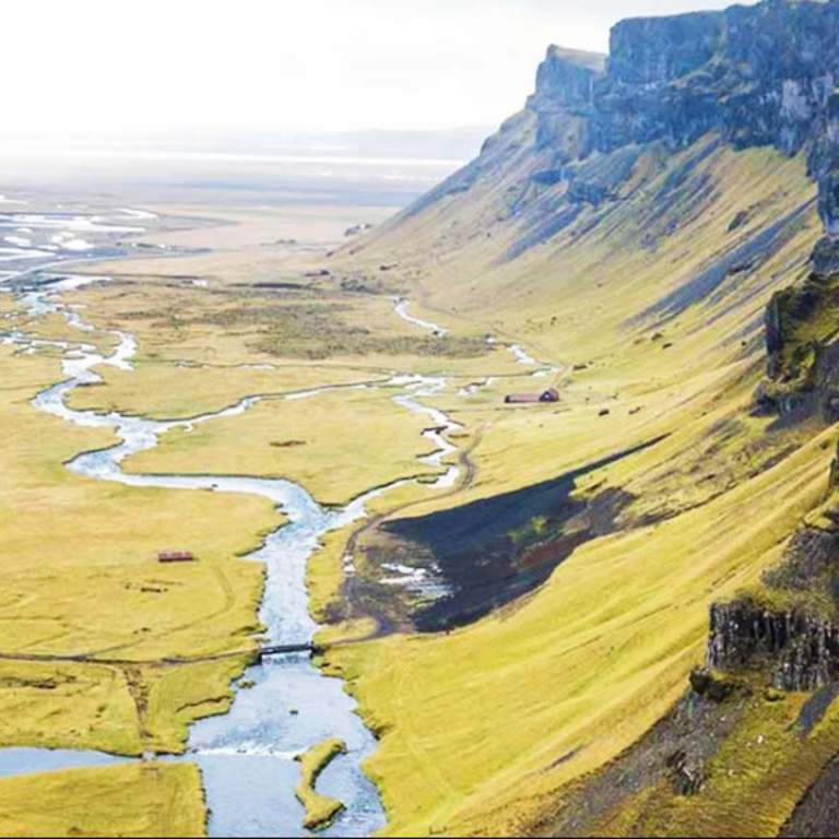 Image of grassy plateaus and a river cutting through.