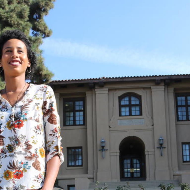 Brandy Taylor standing in front of business building