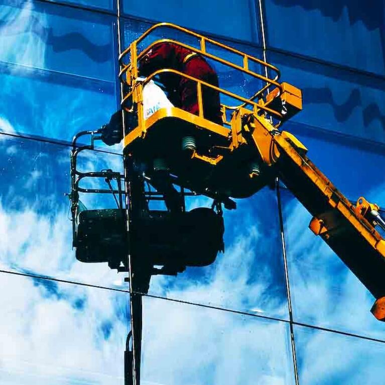 Worker washing windows