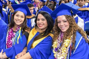 Three Graduates at the UCR School of Business 2025 Commencement Ceremony