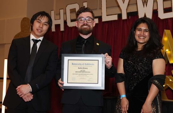 Adjunct Professor of Management Austin Attaway displays his 2024-2025 James Merino Innovation Award