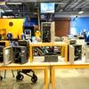 Wooden tables with assorted microscopes in cases