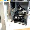 A microscope in a metal case
