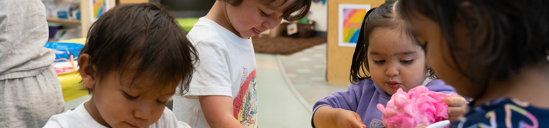 children playing in water bucket with soap