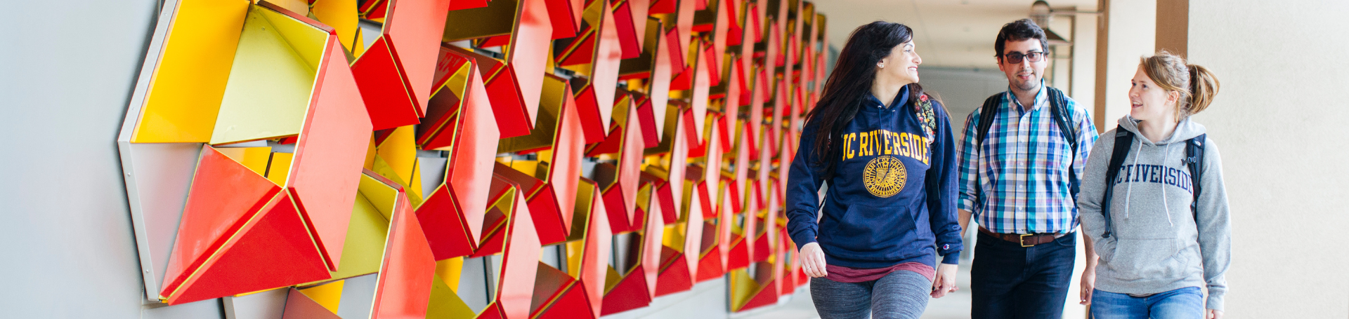 Students walking in front of genomics art