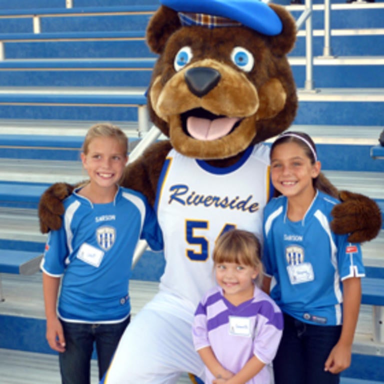 Highlander mascot with children