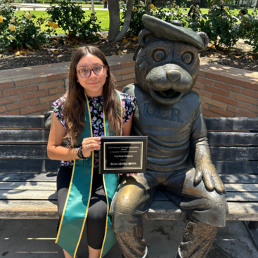 CNAS student sitting by Scotty statue