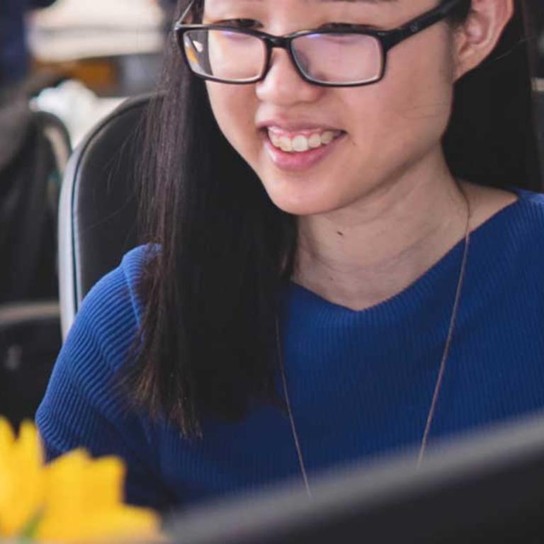 women looking at laptop and smiling