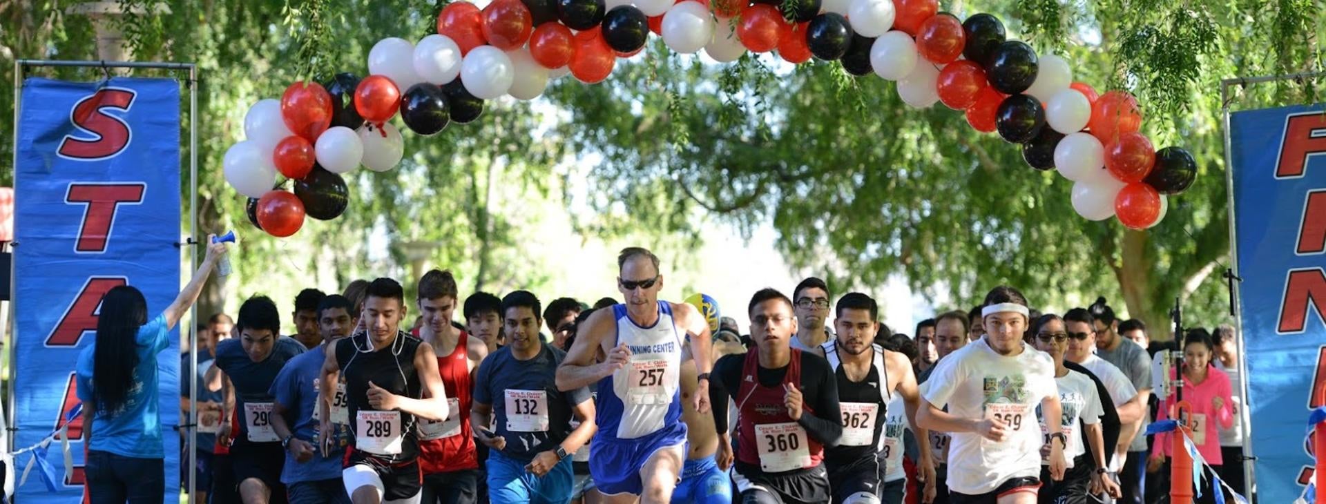 Participates running in the Cesar E.Chavez 5K Run/Walk event