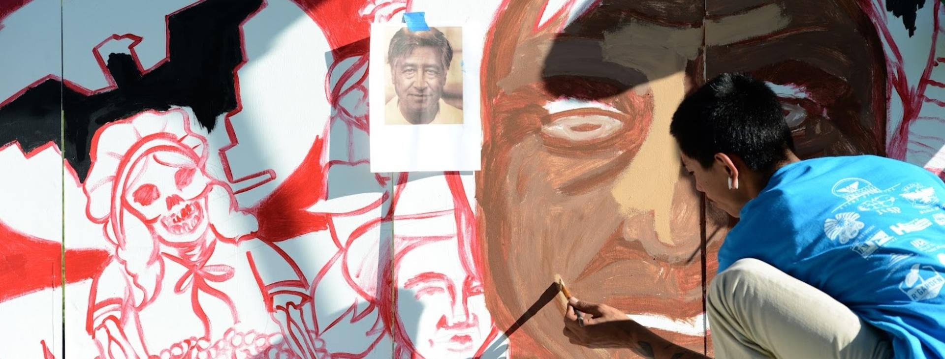 Event staff painting a mural during the Cesar E.Chavez 5K Run/Walk event