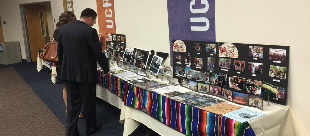 CSP Alumni looking at a table of past memories. Down memory lane