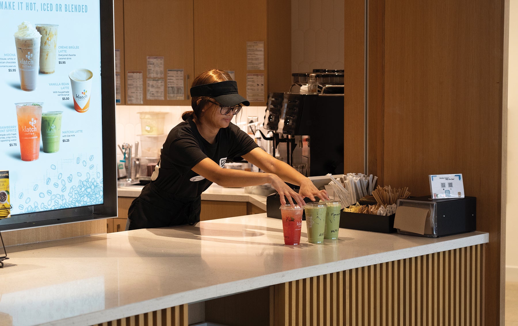 student employee serves Biz Cafe drinks