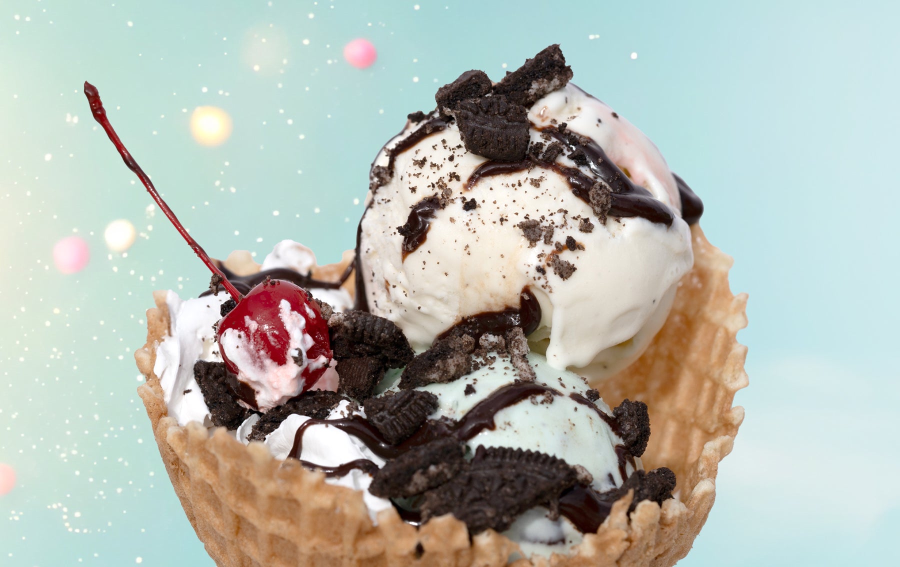 three scoops ice cream with oreo topping and cherry