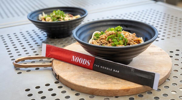 NOODS branded chopsticks with noodle bowls
