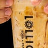 A Lollicup employee puts the lid on a drink.