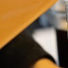 An employee pours a liquid into a Lollicup cup.