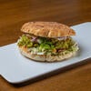 A Falaffel Pita Wrap on a white plate.