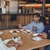 Three students eating inside at Glasgow.
