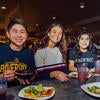 Three students eating inside at Lothian.