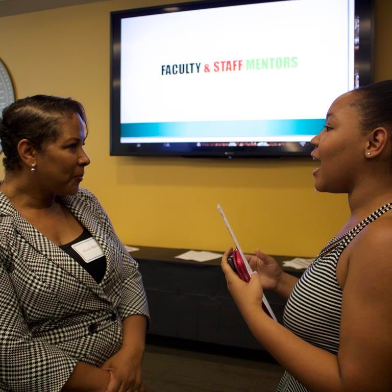 Nicole Butts talking with a student