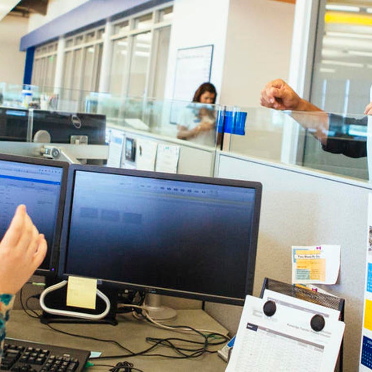 Staff members working and talking