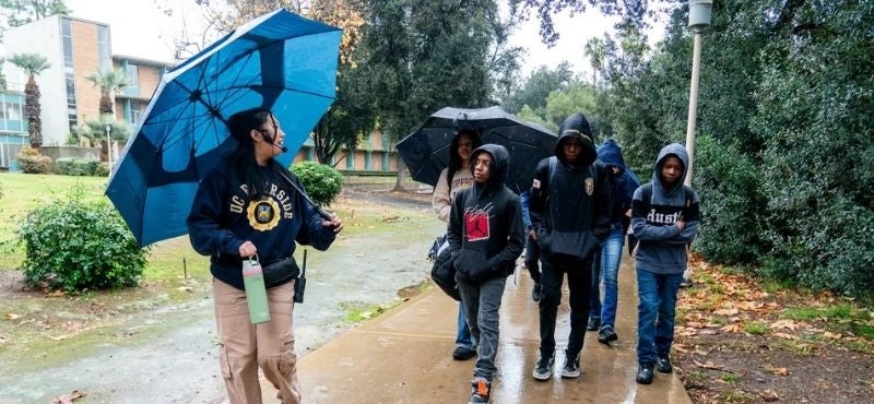 Middle schoolers walking in the rain