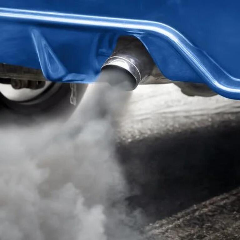 Car exhaust coming from a blue car.
