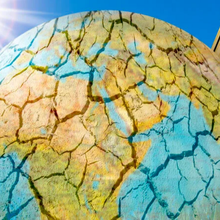 Image of cracked earth and thermometer showing high temperature.