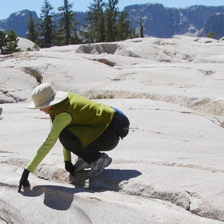 Person looking at rock formations of a subglacial river.
