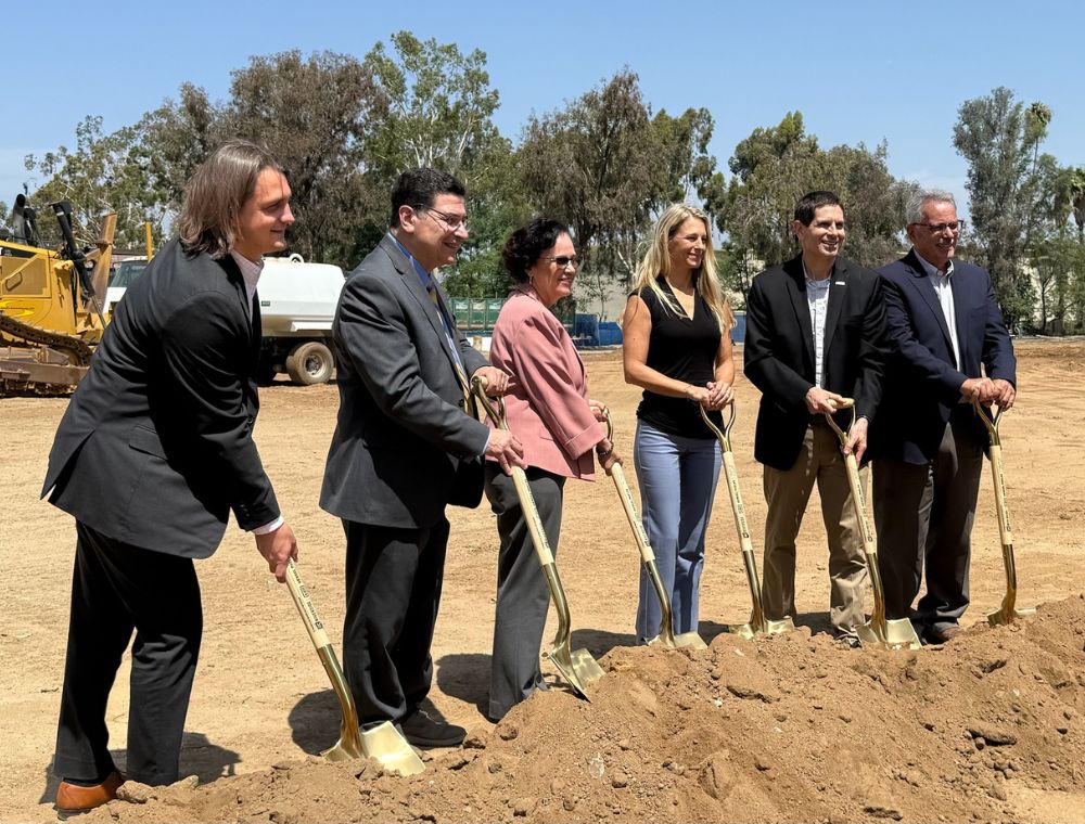 OASIS groundbreaking with several stakeholders holding shovels in the dirt