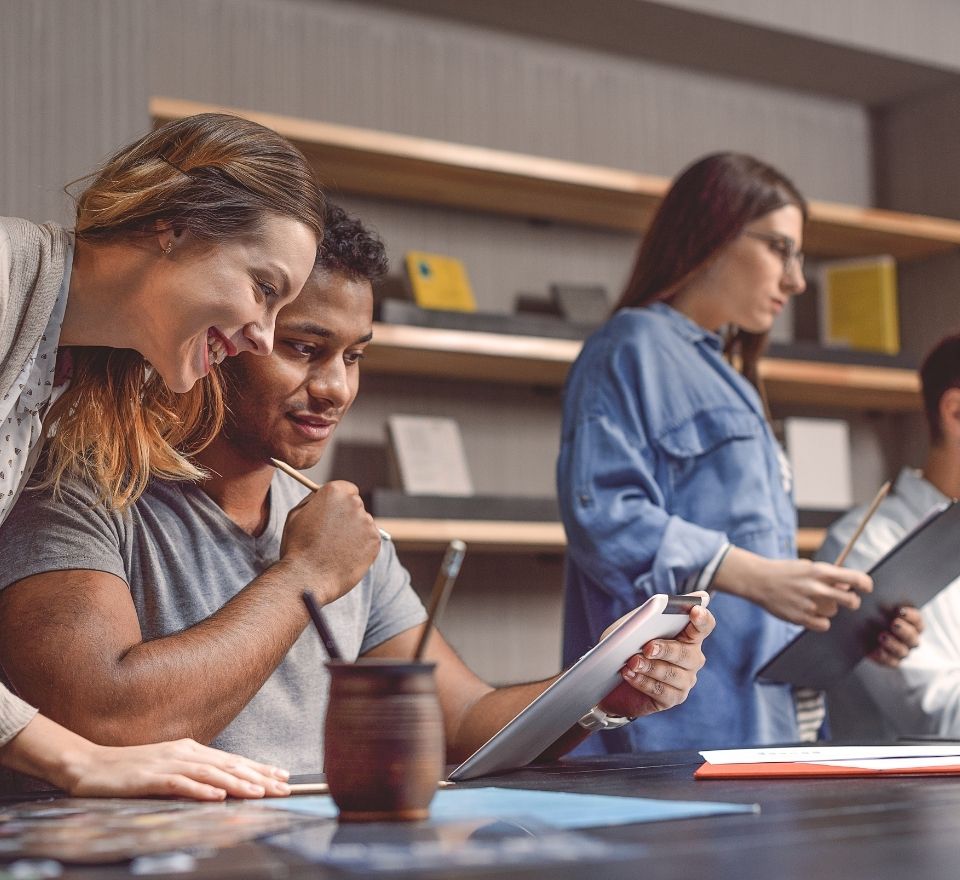 College students working on a project in an office setting