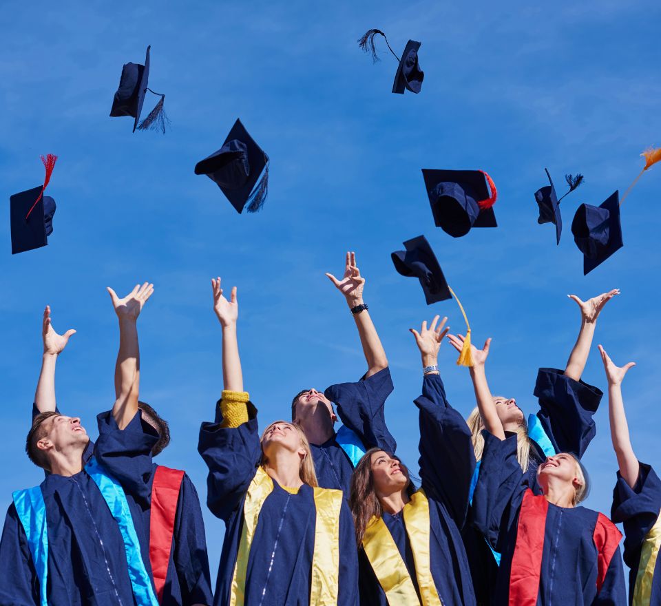 College grads throwing their caps in the air in celebration