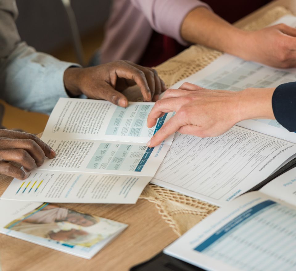 Individuals looking at a healthcare brochure