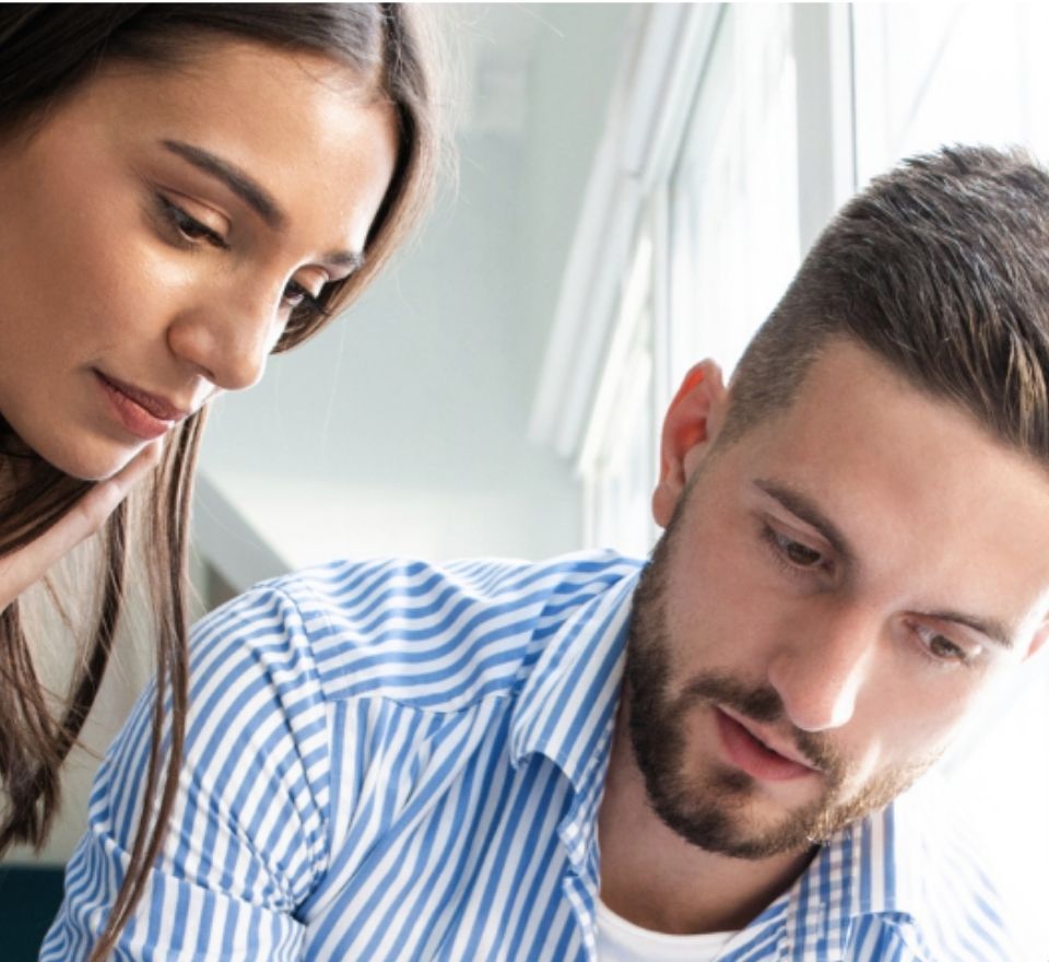Man and woman looking over a project plan in an office setting
