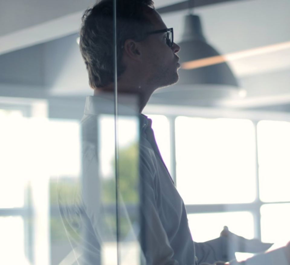Professional man looking off into the distance as he ponders about his project