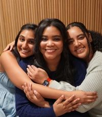 UCR University Extension graduate Sahara Powell hugging two friends