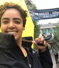 UCR University Extension graduate Sahara Powell standing in front of the Galway sign outside