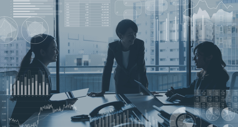 Three female business professionals discussing around a table