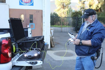 Central Plant supervisor controlling a submarine drone on a table